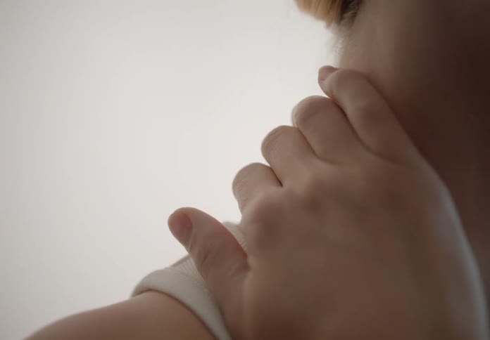 Woman touching her neck with her hand