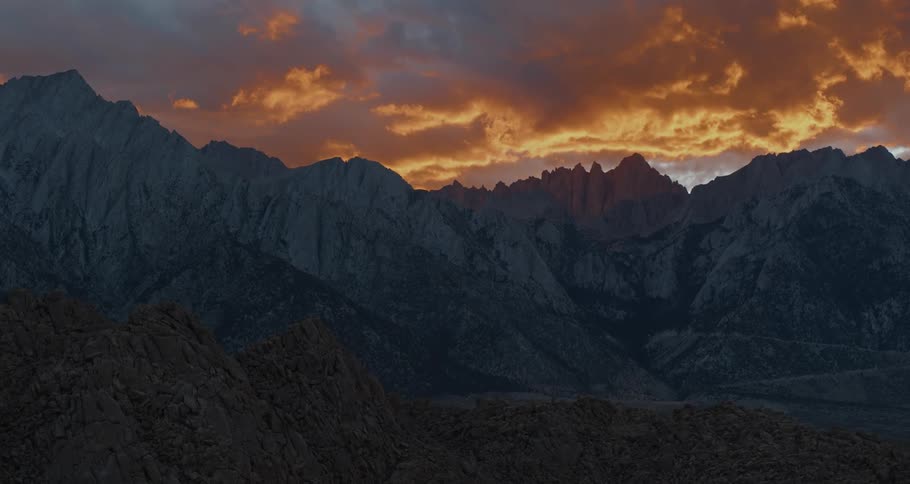 A mountain ridge under a cloudy daytime sky