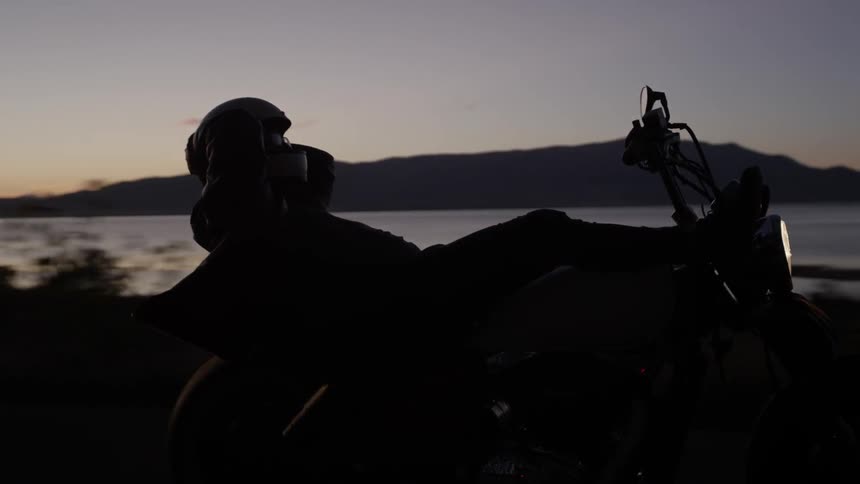A person lays back while riding a motorcycle