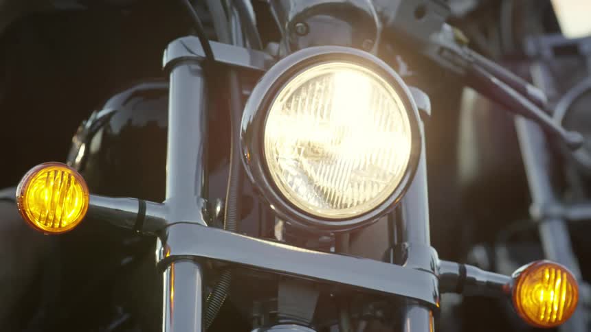 The headlights of a motorcycle are turned on
