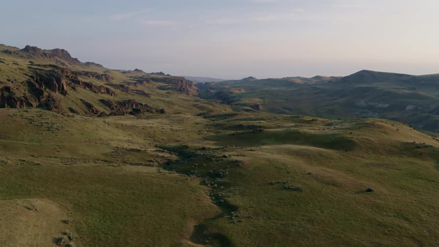 Traverse over beautiful rolling plains leading up to a rocky canyon