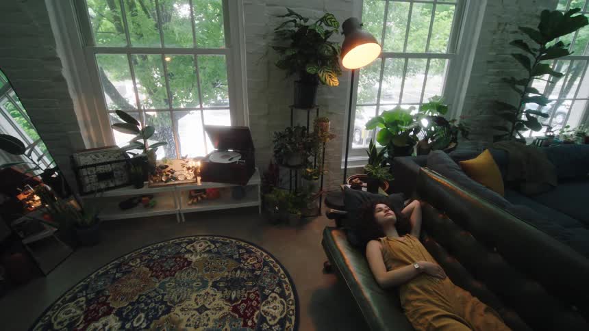 Girl lying down on a leather couch