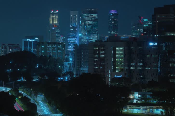 Skyscraper under construction grows in downtown city at night