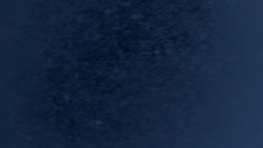 In the dark of night the wind blows around small snow flurries