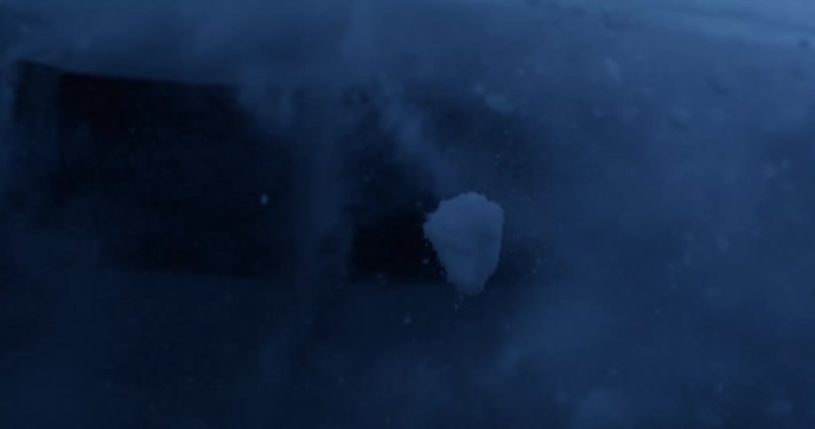 Pieces of ice and snow are seen launching into the air in the dark of night