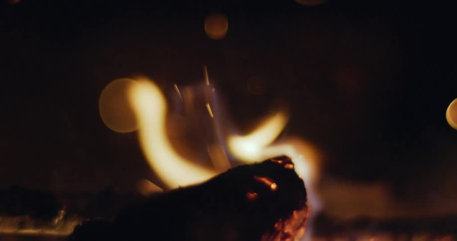 A few small pieces of wood are engulfed in flames as they burn