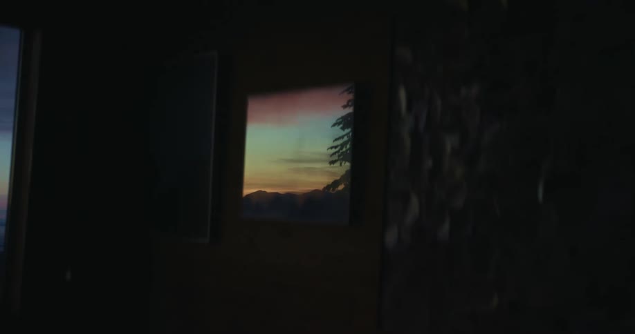 A beautiful sky and a tall tree are visible through a small window