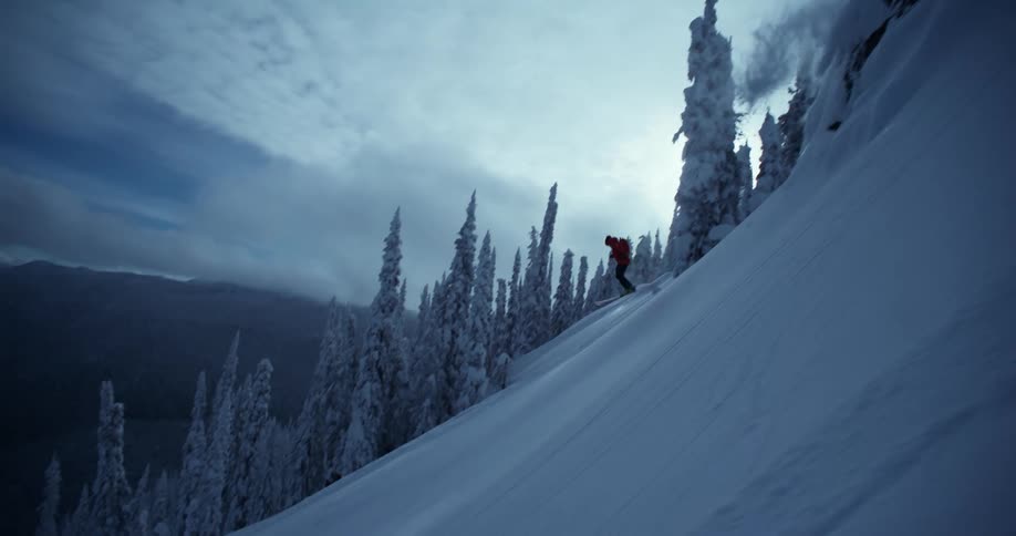 Man practicing snow skiing jumping off a mountain