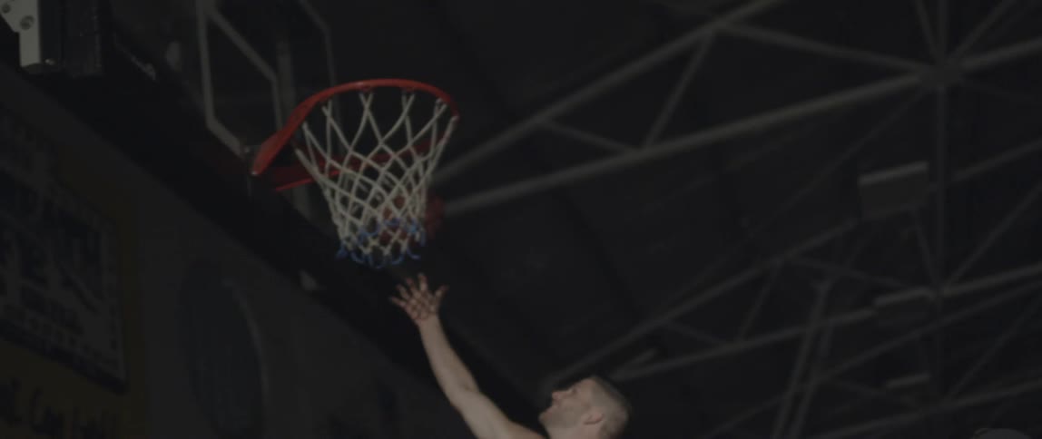 Two people play basketball together