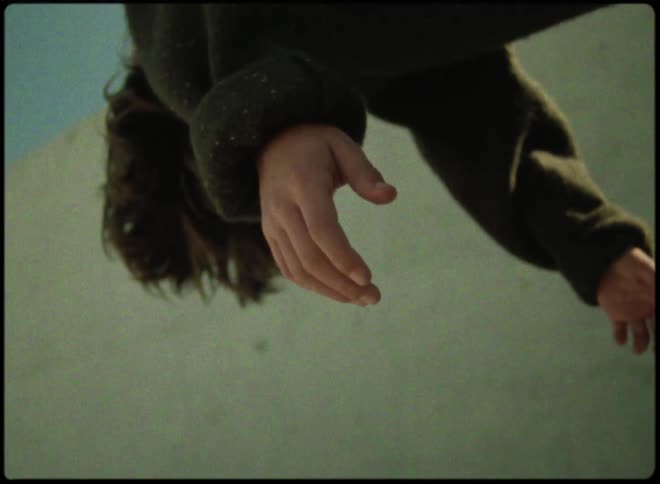 A person is motionless as their arms dangle while theyre carried