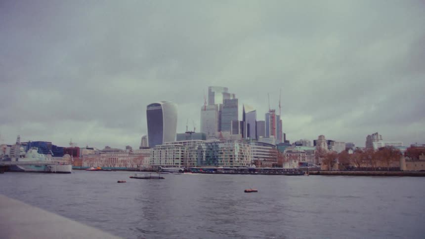 A ship passes by the buildings across the water