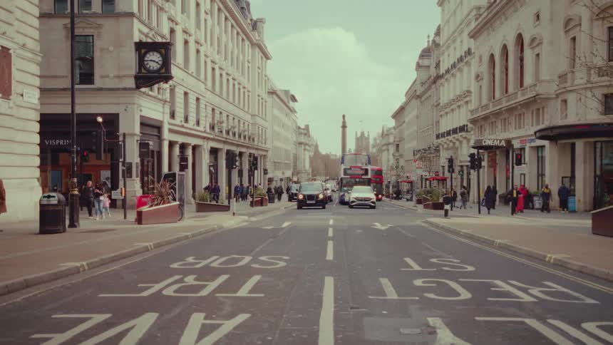 Pedestrians and cars travel through the city