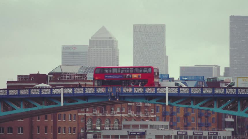 Vehicles and pedestrians cross the bridge in the city