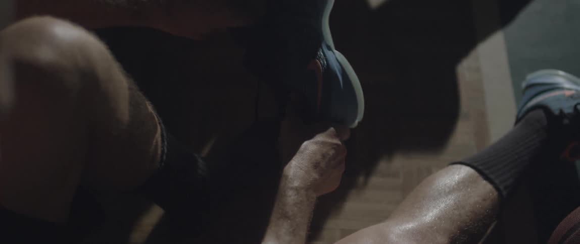 A man puts on his sneakers