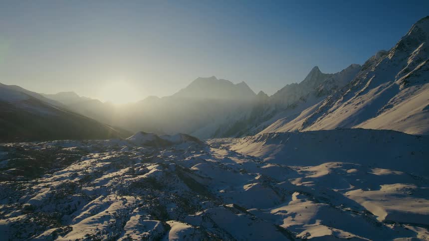 A grassy valley covered in snow