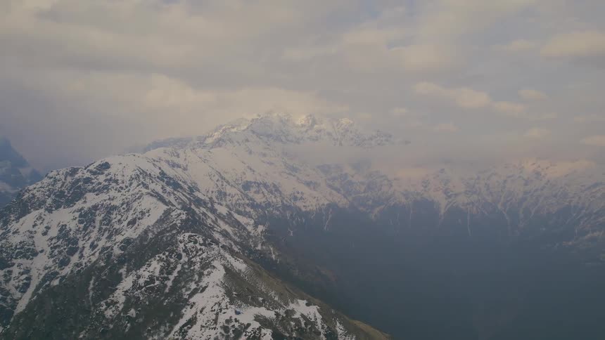 Fog and snow cover the mountains