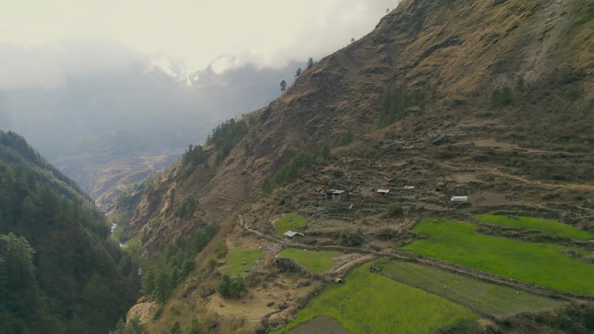 Shelters and homes line the mountain side