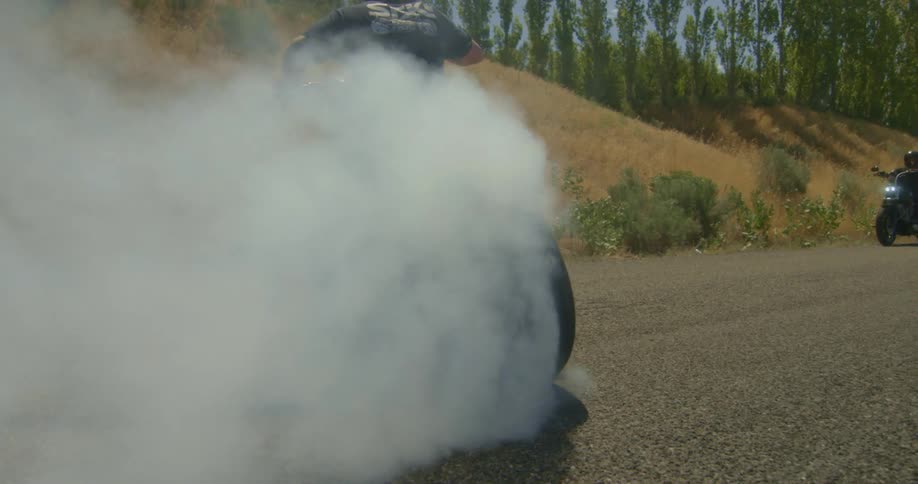 A motorcycle spins out in a circle