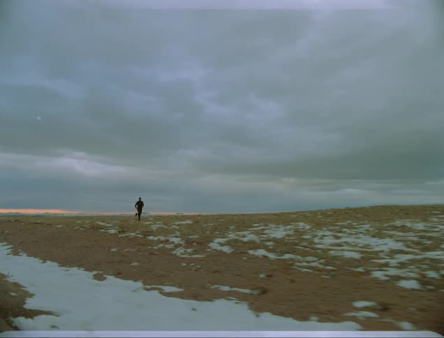 A man running along a field