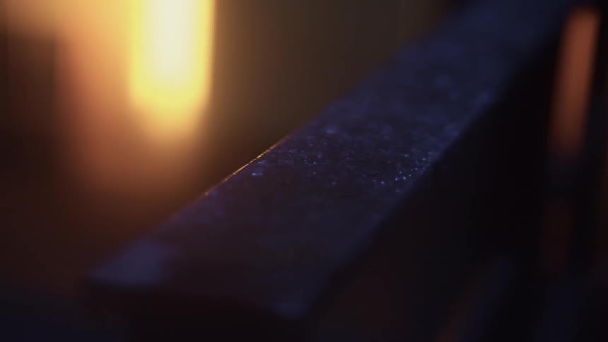 A bar of metal is sitting in front of a bright light