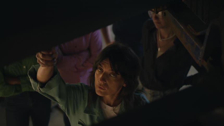 Woman with expression would be turning her hand and people around