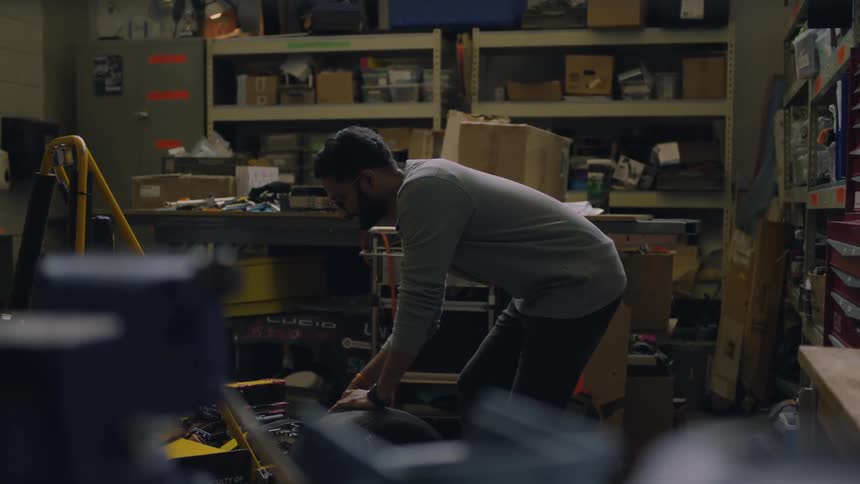 Man on a workshop screwing