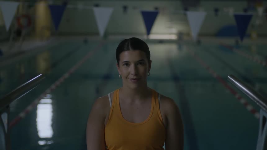 Smiling woman with her back to the pool