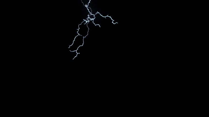 Streaks of lightning illuminate the dark countryside at night