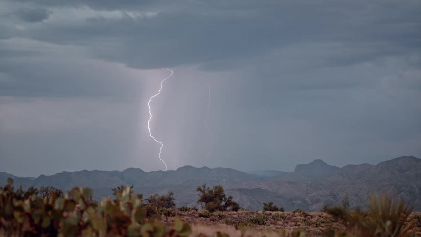 Thunderstorm over mountain range during day time