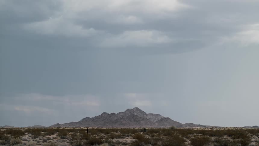 Lightning strikes over a mountain in the desert