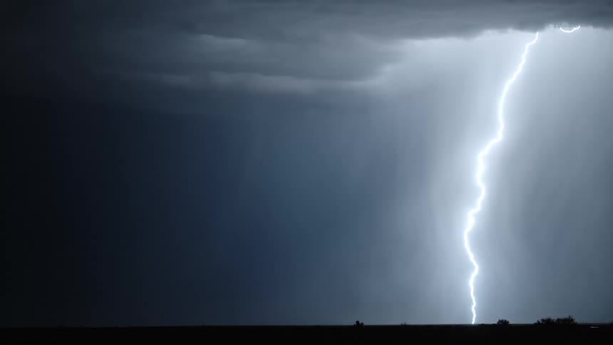 Incredibly bright flashes of lightning illuminate dark storm clouds