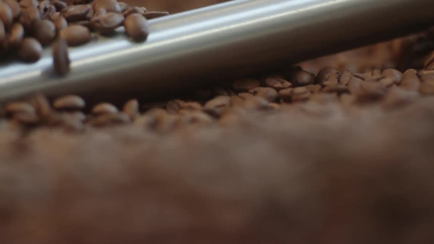 Machine arm in roasting machine keeps coffee beans stirred