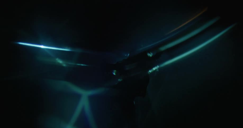 A woman dancing between light beams