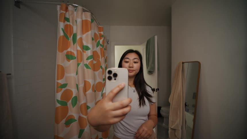 Woman takes a selfie in the bathroom at home