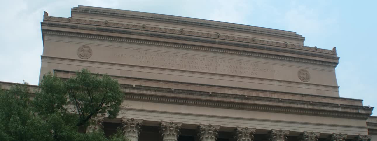 The west side of the national archives building with inscription against a blue sky