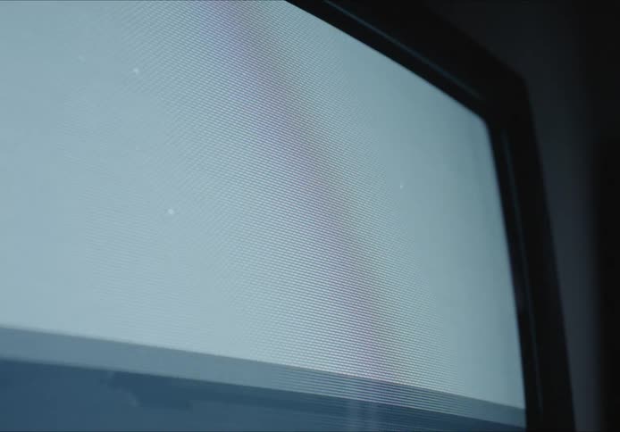 A television showing green screen and then loosing its signal in a dark room