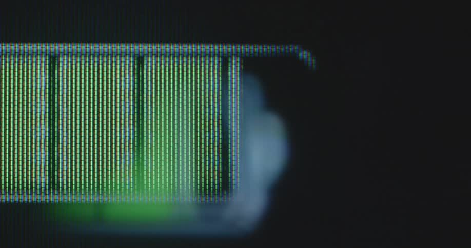 Dynamic panning shot of a battery indicator symbol that fills up and depletes from left to right changing colours between red and green as the battery charger completes the fast charging process while maintaining a long battery life