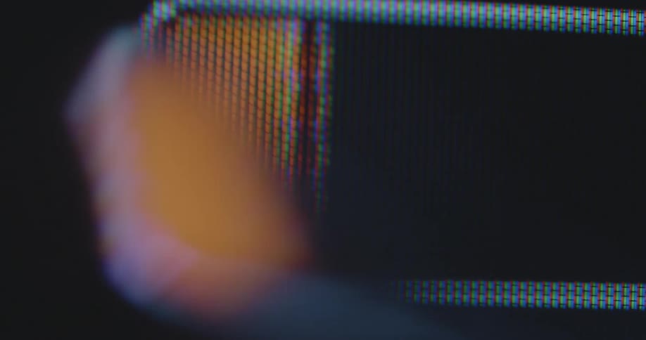 Dynamic handheld macro shot of a battery symbol on a pixelated digital screen fills up and then drains repeatedly creating climax tension suspense during the charging and energy consumption process
