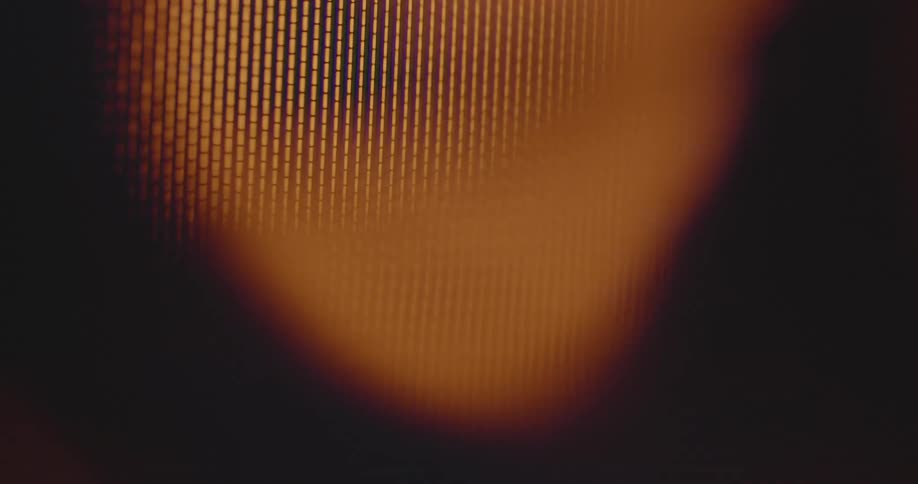 Shaky handheld dynamic closeup of blurry golden neon lights forming circular patterns on a dark background with high contrast and dynamic movement like alarming warning signal causing stress and panic on old pixelated computer screen