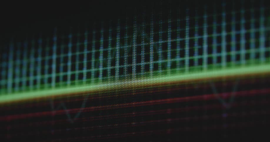 A digital investment graph trend line shifting between going up and down as a stock trading market prognosis or index of the finance sector affected by the global economy in the darkness on black flickering retro computer screen