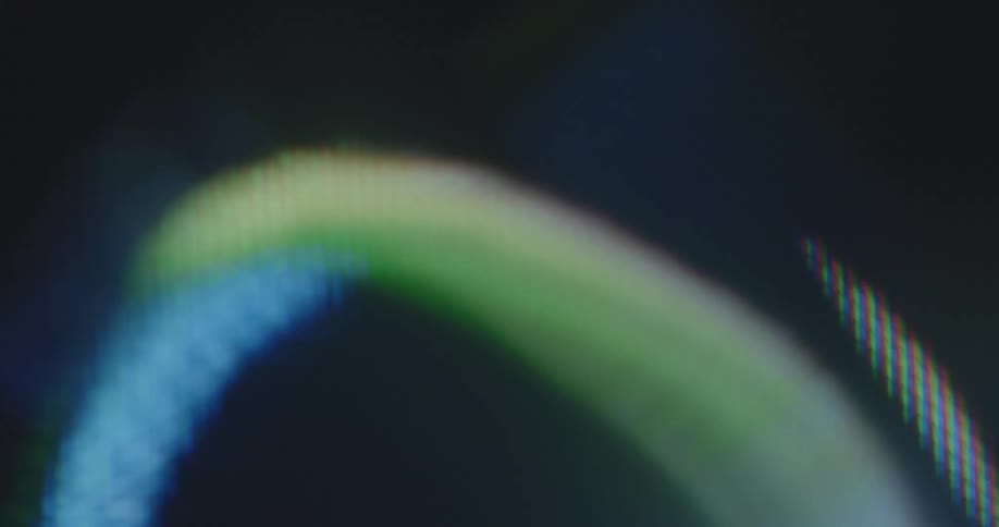 Extreme macro footage of a pixelated computer screen that displays a colorful LGBTQ+ graphic of concentric rings rotating and spinning as a symbol for tolerance freedom and pride connected to homosexuality bisexuality and transsexuality