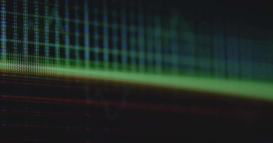 The camera captures an extreme closeup of a screen as a graph of a share index traded at Wall Street or on an online stock exchange app is plotted while going up and down or falling or rising and changing between positive green and negative red