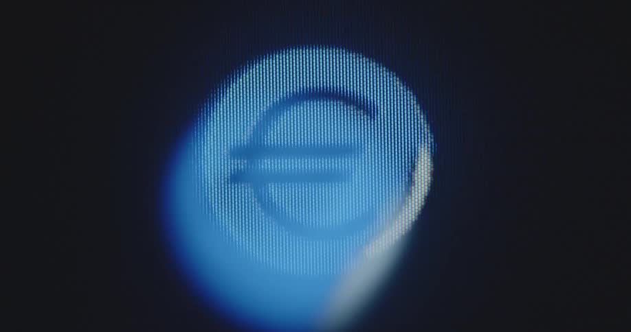 A modern and extreme macro closeup of an old computer screen that shows a dynamic image of a digital Euro logo in the colours of the European Union that is moving and pulsating