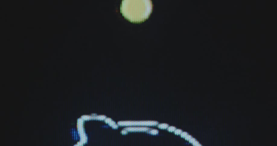 Dynamic macro close up of gold penny being collected in neon piggy bank money box icon on vintage TV screen symbolizing putting money aside by buying an ETF stock portfolio or saving on a bank account for profitable interest rates