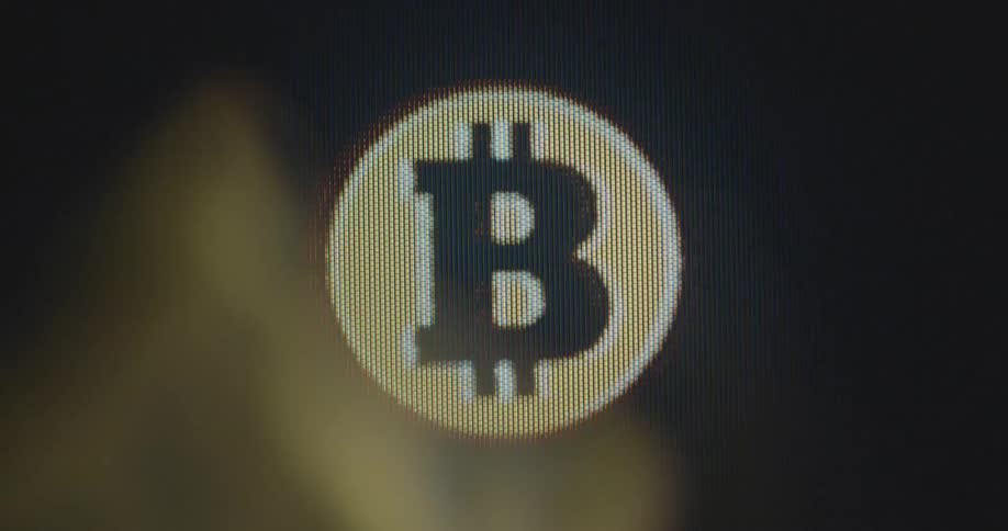 Projection or animation of a dynamic bitcoin icon or logo is displayed on pixel laptop screen as a symbol for the power of trading crypto currencies and digital assets allowing financial security providing great investment possibilities and chances