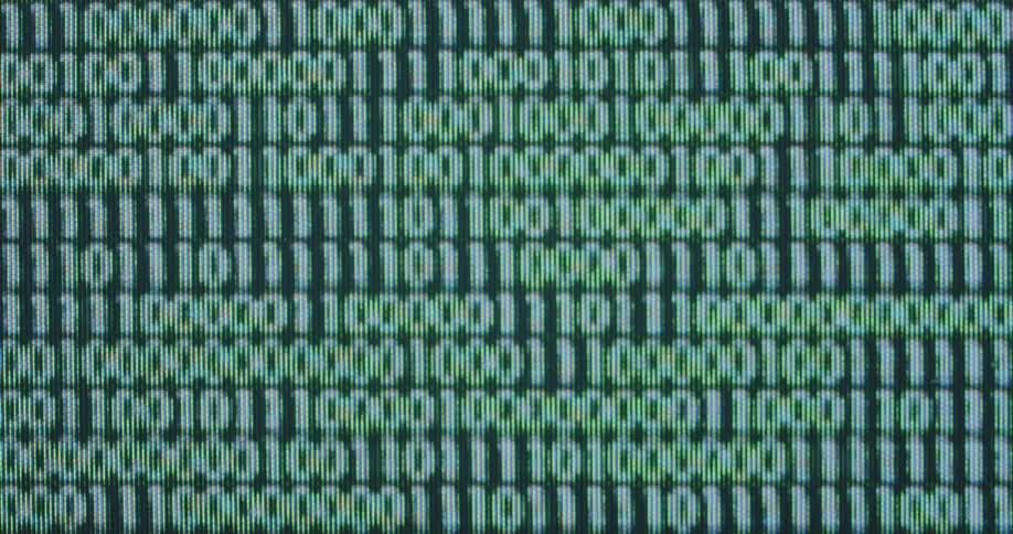 The neon green automated numbers zero or 0 and one or 1 flash change and move on an old pixelated computer monitor during process of web development or computer programming performed by an artificial intelligence or online network coder