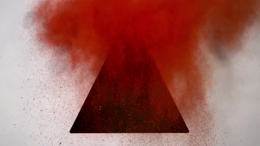Red dirt flies from a triangle