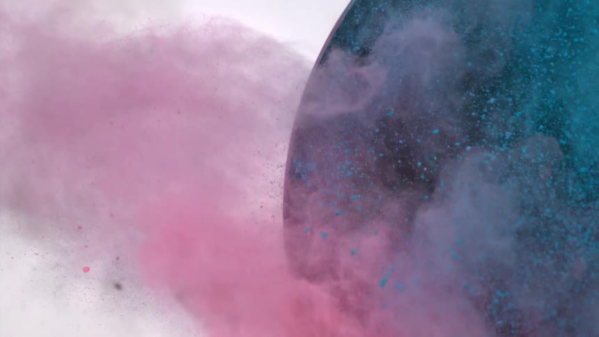 Purple and blue dirt swirl together coming from a black circle