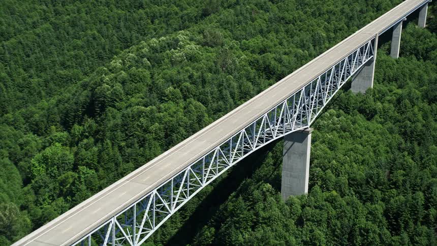 Approaching the Spirit Lake Highway bridge on a sunny day with lush forest below in Cowlitz County Washington