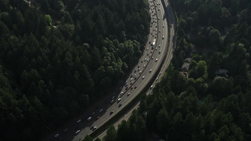 Aerial view of traffic traveling along Highway 26 through a wooded area near the Children's Museum in Southwest Portland Oregon during the day